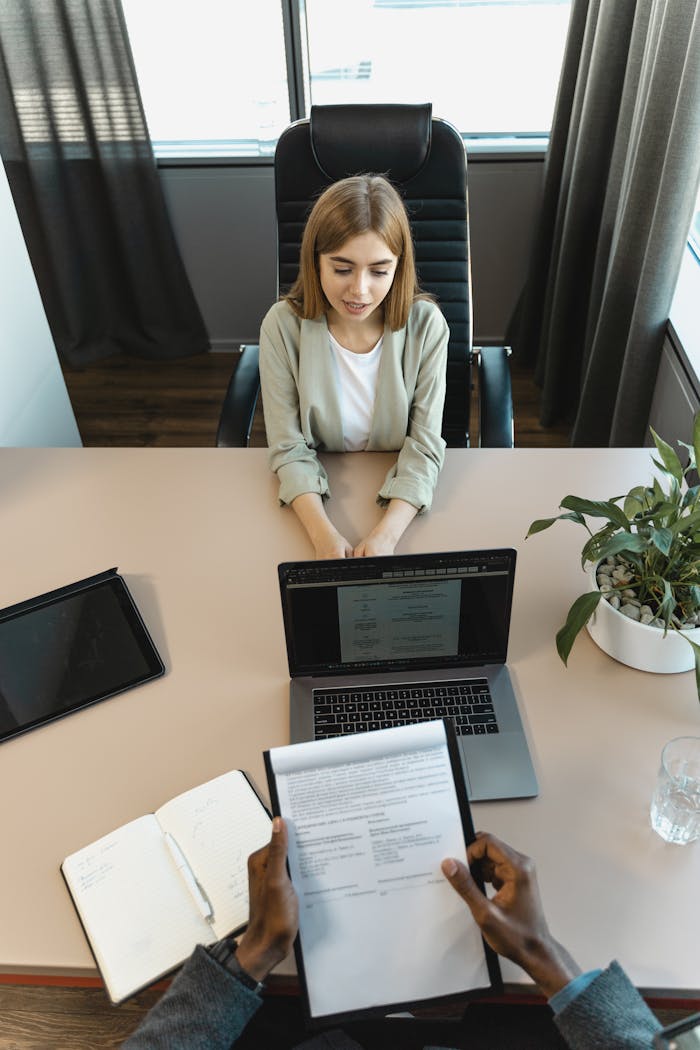 High-angle view of a job interview in a modern office setting, capturing professionalism.